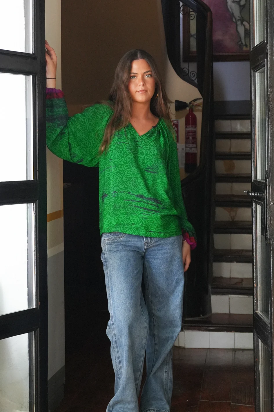 Front of the green sissel edelbo blouse size s-m shows the fucsia pink sleeve ends and the green combined print